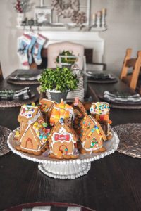 Display gingerbread houses on a pretty pedestal #farmhousedecorating #christmasdecorating #gingerbreadvillage